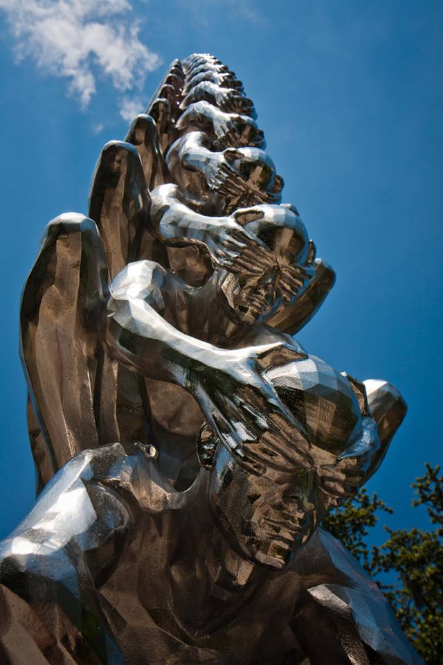 Karma is an intriguing sculptural installation by Korean artist Do Ho Suh that presents countless men sitting atop one another while shielding each other's eyes. Like his Cause & Effect piece, which features a spectacular tornado of figurines, Karma presents figurative sculptures ascending into the sky like a human ladder. 