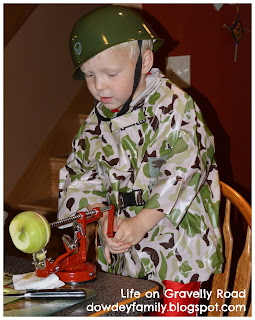 boy in costume using apples slicer