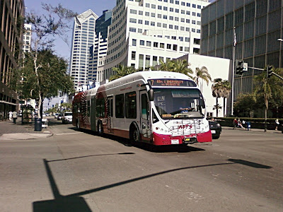 San Diego Metropolitan Transport System number 7 Bus  Red and White painted bus on Broadway