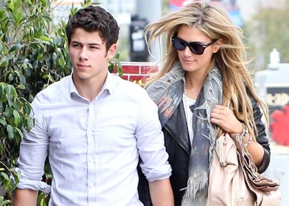 Nick Jonas and girlfriend Delta Goodrem hand-in-hand
