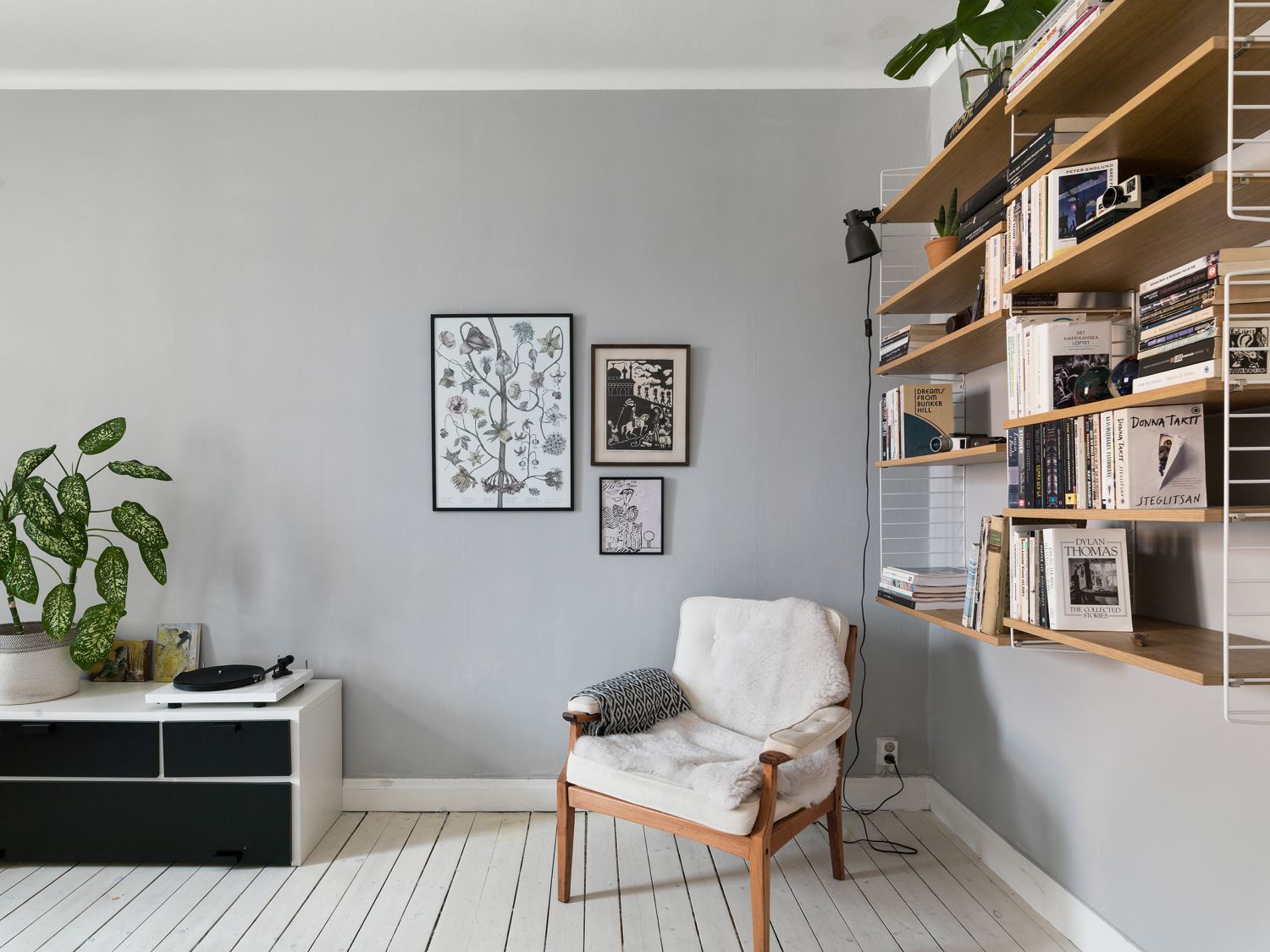serene scandinavian duplex apartment with botanical print, white floor and string shelf