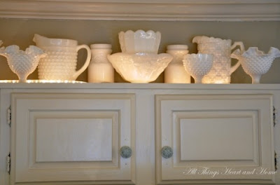 mylittlehousedesign.com uplight milk glass on top of kitchen cabinets