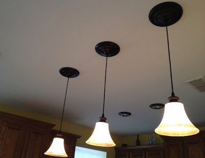 This kitchen ceiling sports three instant pendant lights in a bronze finish.