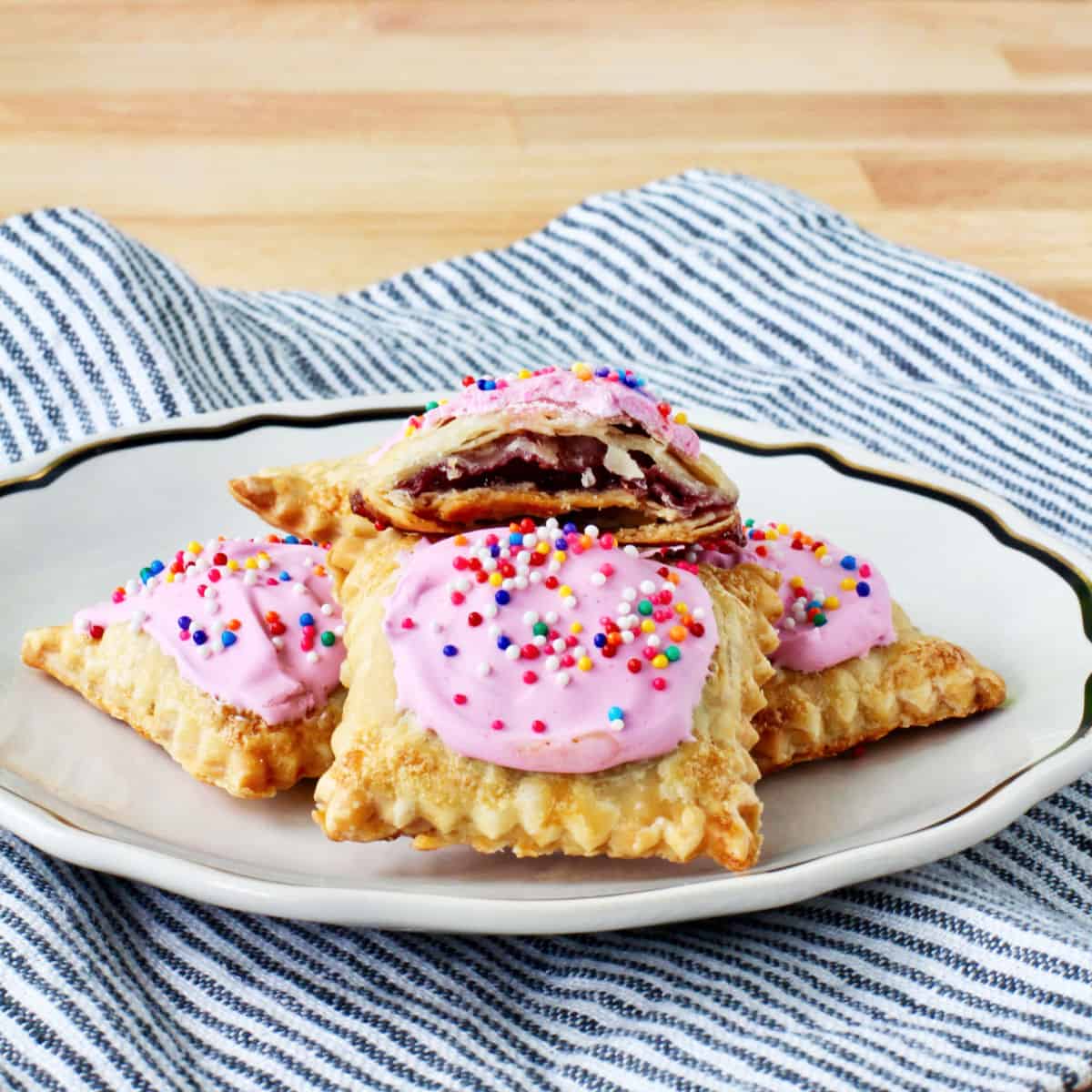 Tiny Homemade Pop-Tarts on a small plate with a bite taken out.