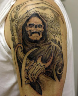 Grim Reaper tattoo covering the shoulder and the upper arm