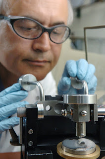 Argonne researcher Ali Erdemir performs a friction test on a metal disc coated with a solution of motor oil with nano-boric acid particles