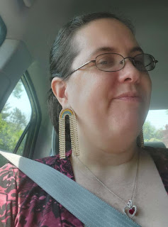 Me wearing sparkling dangling rainbow earrings