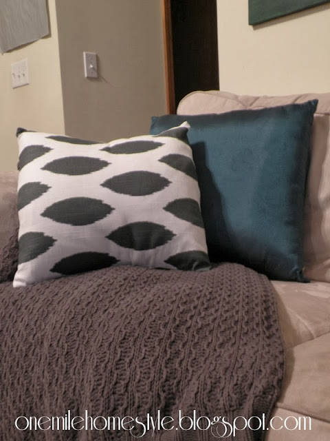 White and Dark Gary covered pillow with gray throw blanket