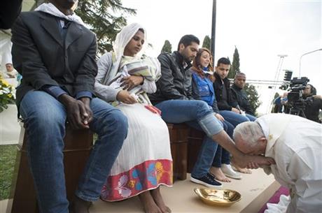 Picture of Pope Francis kissing the feet of a man at the Holy Thursday rite, held at the Castelnuovo di Porto refugee centre in Italy, March 24, 2016, where he washed and kissed the feet of 12 people including Muslims, Hindus and Christians. Photo by AP