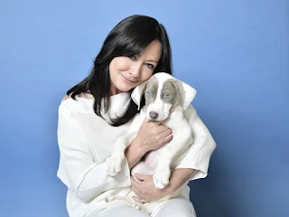 Shannen Doherty, actress known for her roles in "Beverly Hills, 90210" and "Charmed," smiling with her pet.