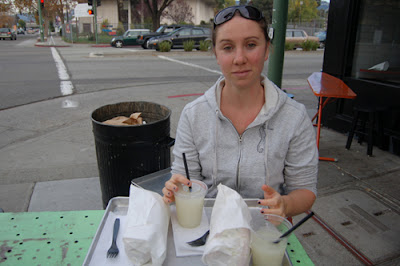 Naushon, my restaurant review partner in crime sitting at an ironing board with our lunch order