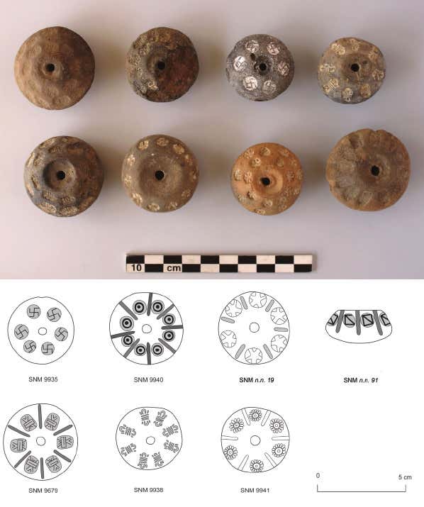 Nubian (Meroitic kingdom) spindle whorls, one of which is decorated with swastikas.