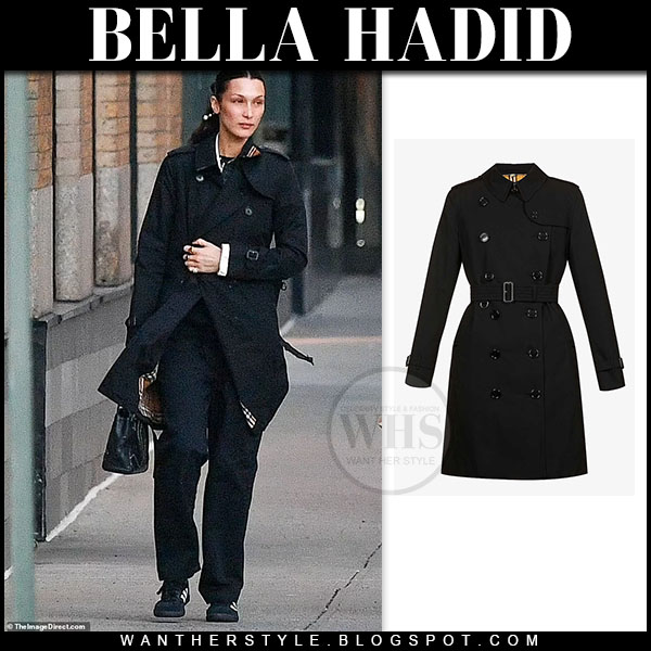 Bella Hadid in black trench coat and black sneakers