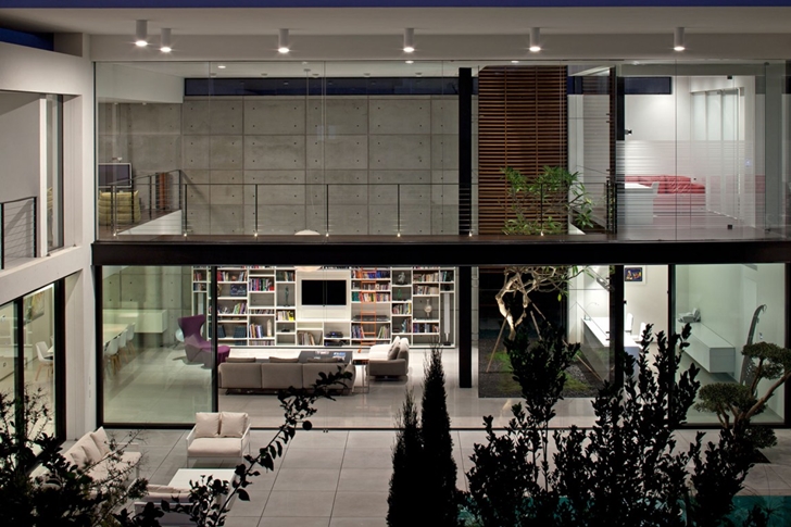 Glass wall at night in Modern Bauhaus Mansion In Israel 