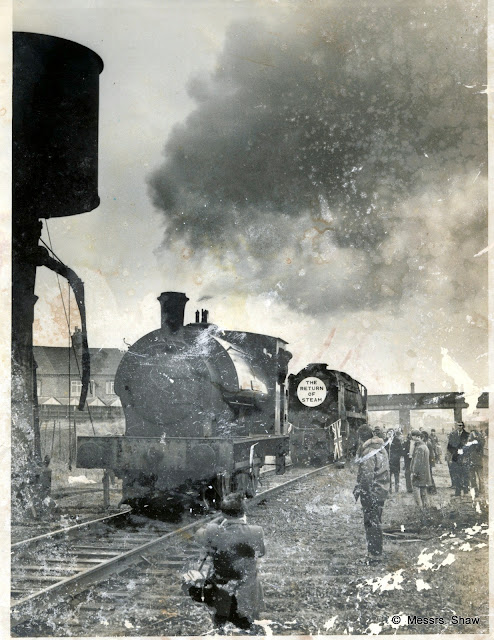 Group of people very close to the train tracks watching a steam engine, black and white