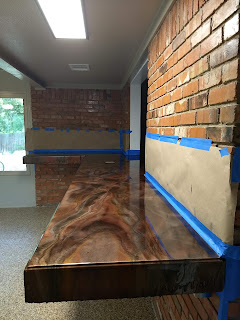 Picture of long counter top. The counter top is brown and copper swirled.