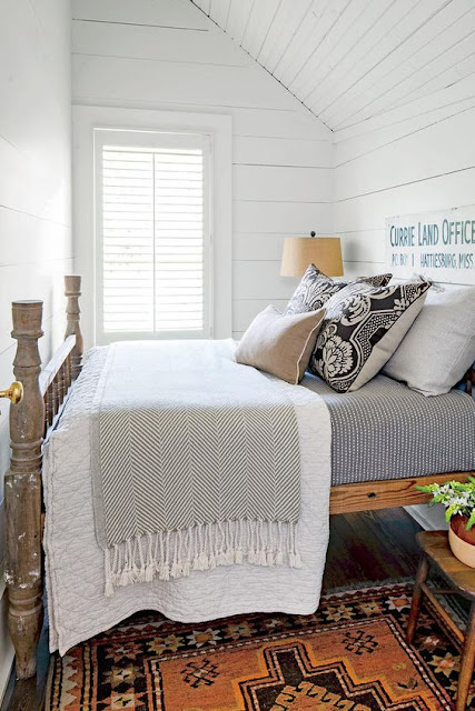 Charming farmhouse bedroom with bold colorful rug and shiplap walls - found on Hello Lovely Studio