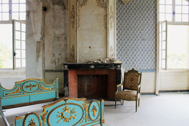 Fanciful blue and gilded gold bed in decaying room of Chateau de Gudanes