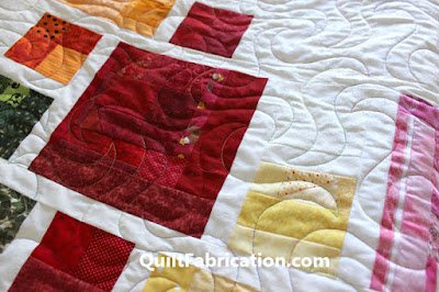 different colored quilt squares on a white background