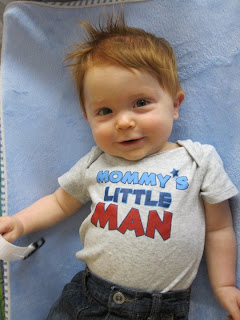 James wearing a shirt that says "Mommy's little man"