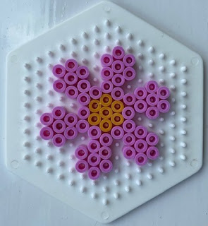 Small Hama bead flower design on hexagonal pegboard