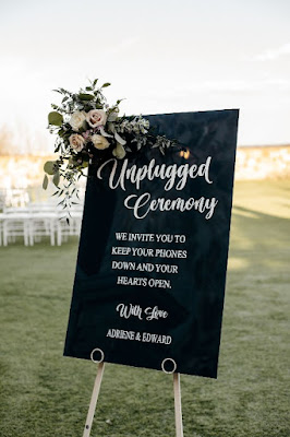 black acrylic unplugged ceremony sign with floral on white at last weddings + event rentals easel