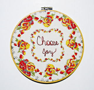 a plate with choose joy in the center and flowers around the plate