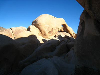 Setting sun Arch Rock Joshua Tree National Park California