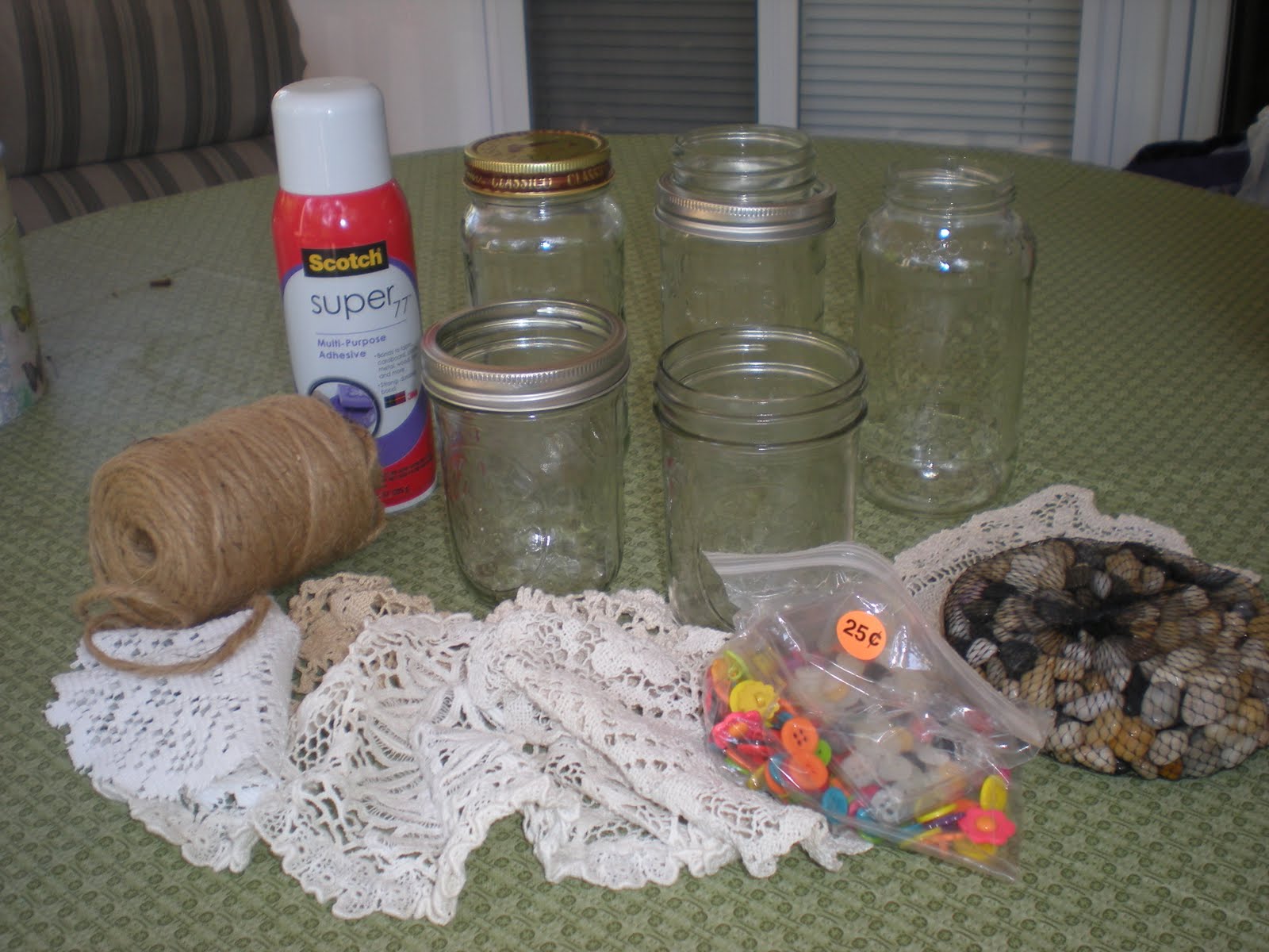 ... what i used a few jars the doilies spray adhesive twine and wallpaper