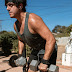 A man lifting weights in a park