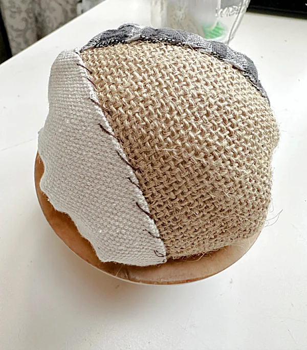 fabric ball in wooden bowl