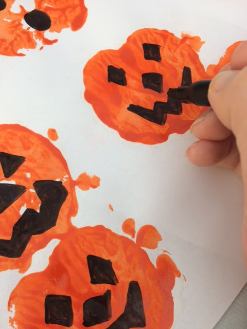 Faces being drawn on the pumpkins