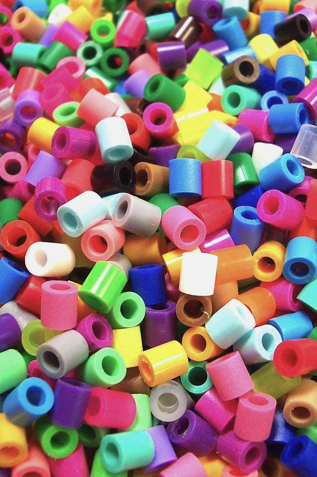 plastic tube beads in many colors in a pile