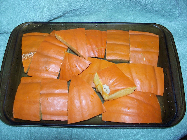 A roasting pan full of pumpkin pieces.