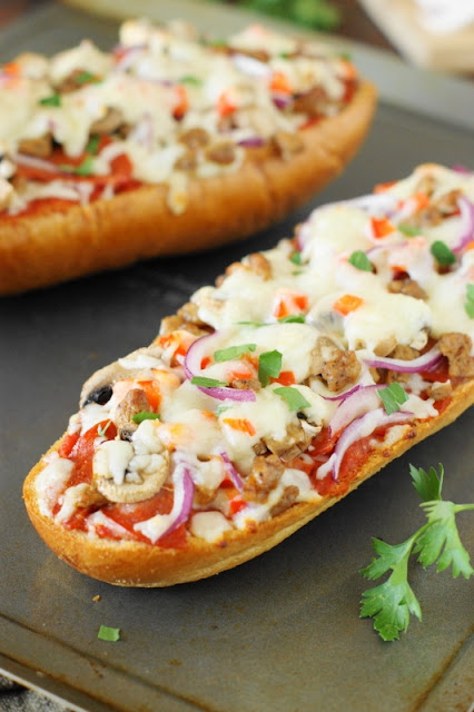 Easy Supreme French Bread Pizza ~ perfect for game-day snacking or an easy weeknight dinner! Loaded with great taste & ready in under 20 minutes.  www.thekitchenismyplayground.com