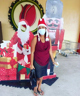 " Shachem Lieuw in front of a christmas prop of Santa"