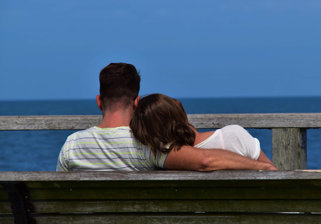 Couple cuddling on a bench