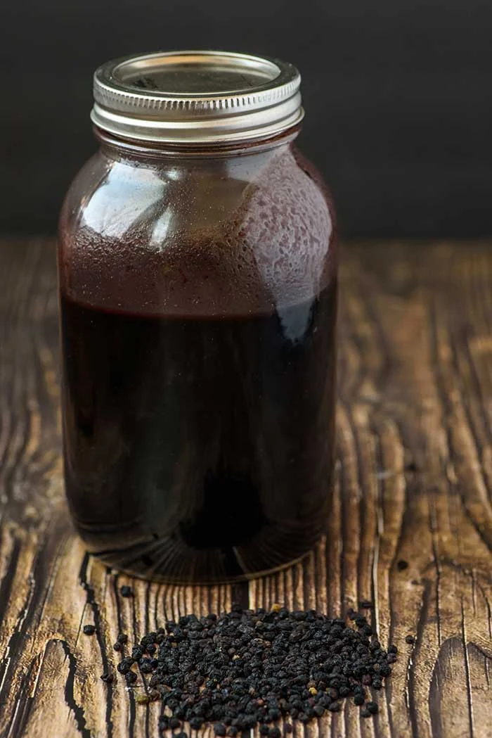 How to make elderberry syrup in your Instant Pot pressure cooker.  Sambucol has many benefits for colds and has been proven to support the immune system.  Also includes the dosage (dose), uses, and how to take a DIY elderberry syrup.  You can also make it thick in your Instapot.  This homemade recipe is cheaper than buying it and has honey for a natural sweetener. #instantpot #elderberrysyrup