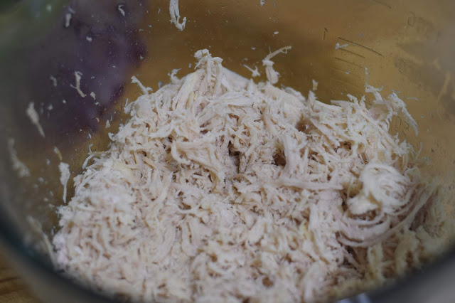 Shredded chicken in a bowl.