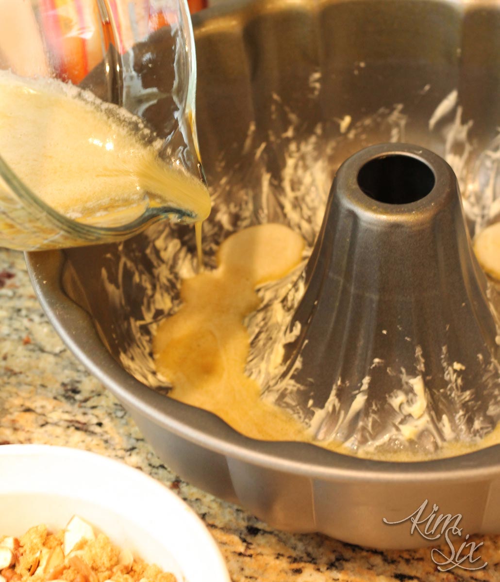Adding butter to bundt pan cinnamon bread