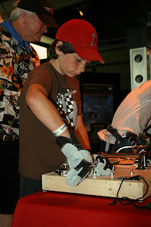 Matt Shezifi of Livermore, Calif., tries out a demonstration that shows how astronauts use tools in space.