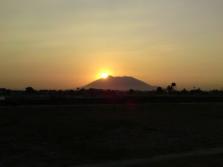 Sun behind the mountain summit