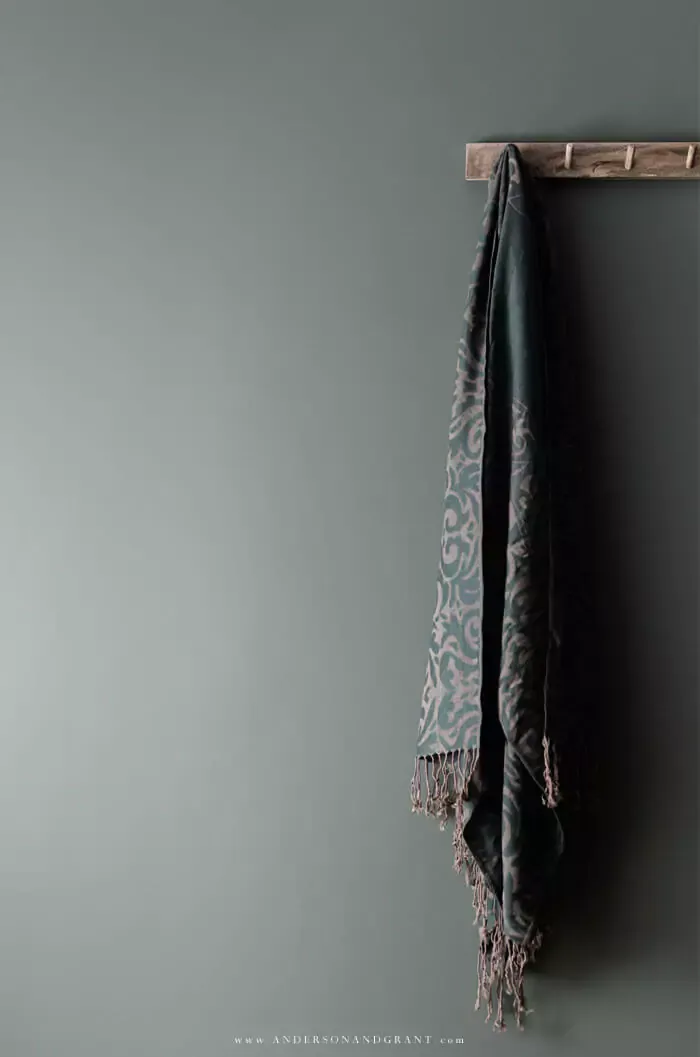 Towel hanging on green wall