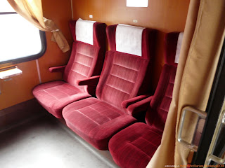 Photo of Old Style CFR or Romanian Railways typical First Class compartment, showing 3 red velvet seats facing another 3