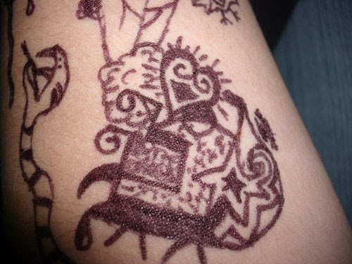 The unique tattoo designs in brown in the hands of a chocolate-themed 