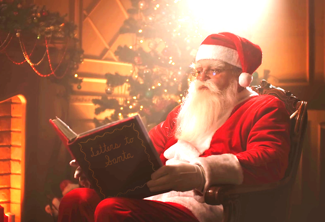 Santa reading the Letters to Santa book