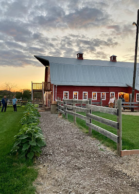 path leading up to the old red barn with sunset in the background