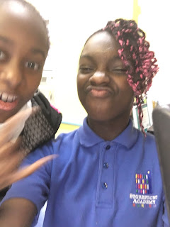 Two Sixth Graders in Harlem smile for a selfie.