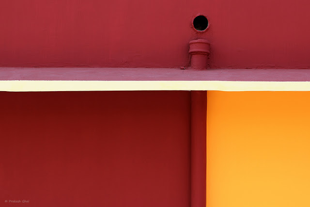 A Red Orange Wall of a Kindergarten School with Simple Geometric Shapes shot via Canon 600D and Canon 100 mm prime Macro L Series F2.8 lens