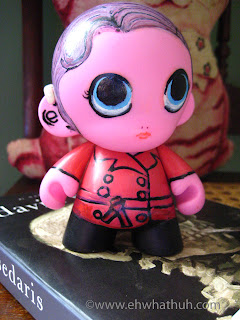 pink plastic doll with hearing aid